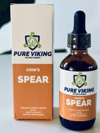 Odin's Spear örtdroppar, 60 ml brun glasflaska med pipett bredvid orange och vit kartong på vitt bord